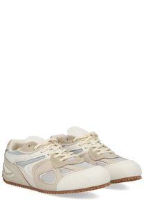 Axel Arigato men’s slow runner sneaker in white with beige and white mesh panels and a rubber sole