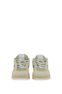 A pair of beige and pale green axel arigato men’s low-top sneakers with a clean minimalist design