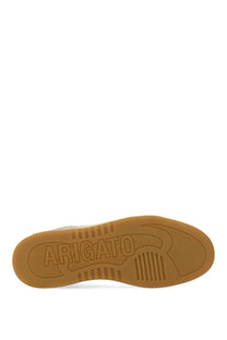 Tan rubber sole with embossed arigato branding and textured grip patterns on axel arigato men’s sneaker dice white