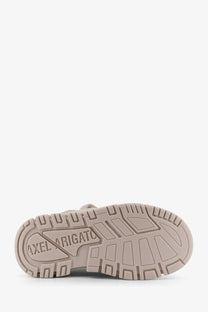 Beige rubber sole with axel arigato embossed in a geometric pattern on axel arigato women’s white suede sneakers