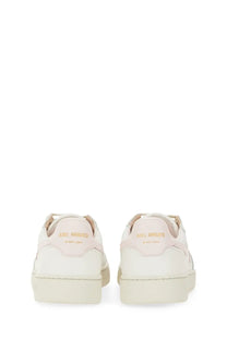 Back view of axel arigato women’s dice stripe sneaker in cream suede and leather with gold-tone heel branding