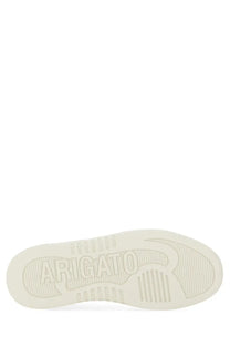 White rubber sole of axel arigato women’s dice stripe sneaker with embossed arigato branding and stylized r logo