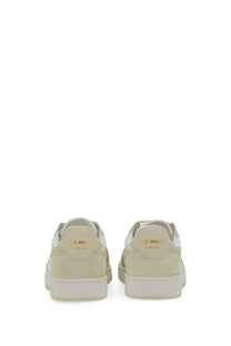 Back side of cream-colored suede axel arigato women’s says lo bee bird sneaker with gold branding on the heel