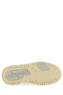 Beige rubber sole with gray axel arigato logo plate on the back of axel arigato women’s sneaker lo area white