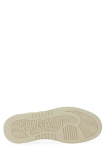 Beige rubber sole with embossed arigato branding and textured grip on axel arigato women’s says white sneaker back side