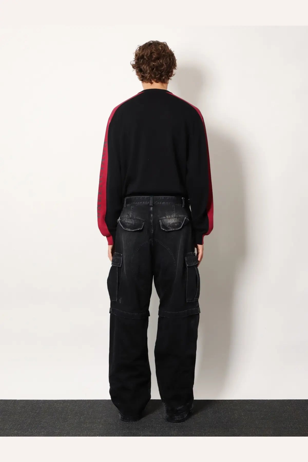 Balenciaga men’s cargo black denim trousers with prominent side pockets and relaxed wide-leg silhouette