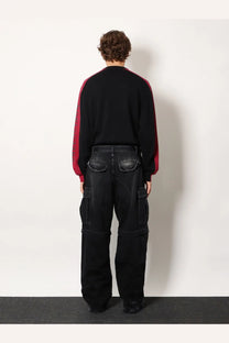 Balenciaga men’s cargo black denim trousers with prominent side pockets and relaxed wide-leg silhouette