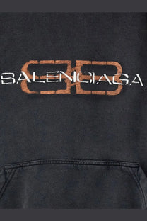 Balenciaga men’s black cotton hooded sweatshirt with a distressed orange and white logo print on front