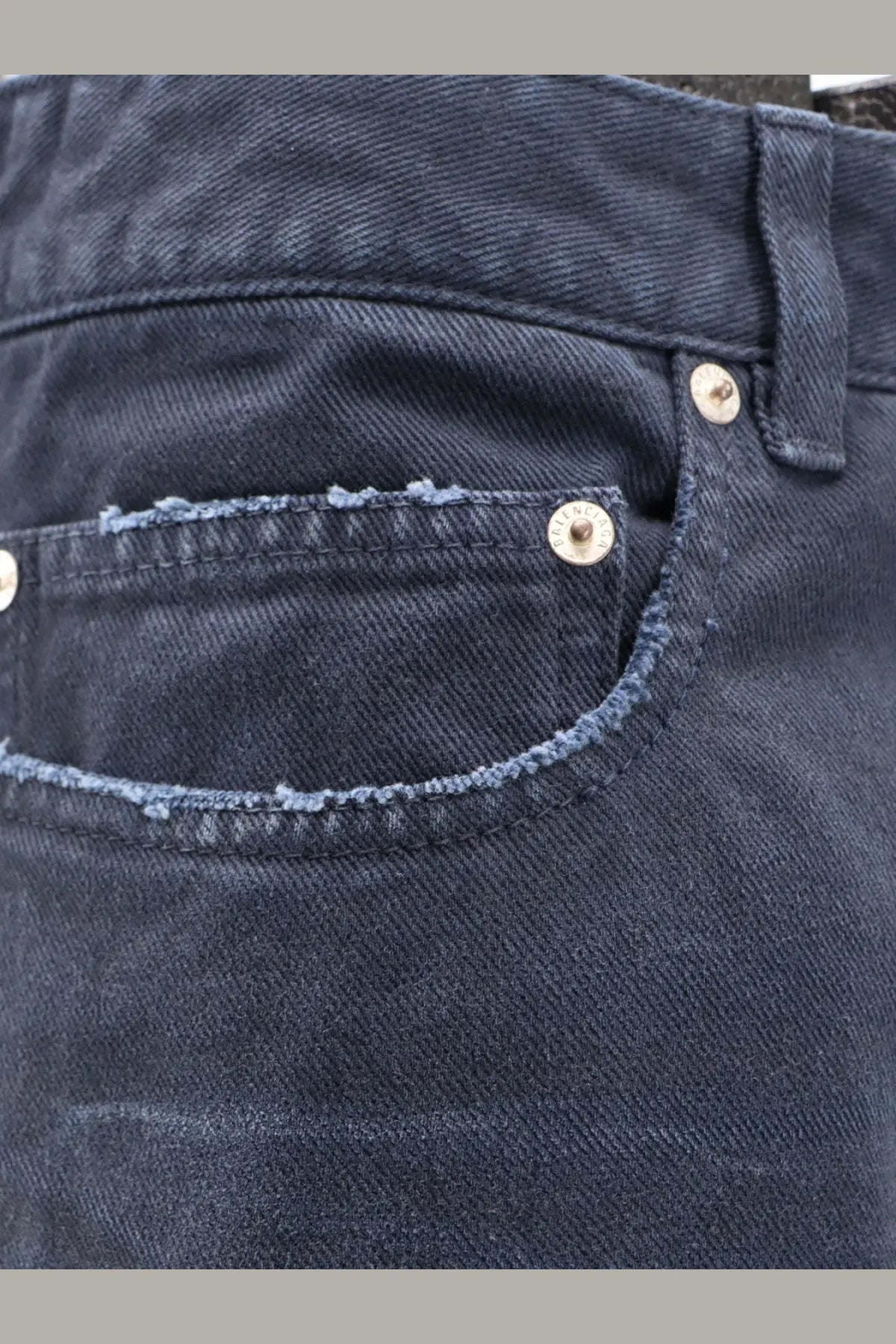 Balenciaga men’s cotton jeans blue dark-wash denim with frayed hem and silver-toned metal buttons