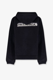 Balenciaga men’s black cotton sweatshirt showing the back with a distressed white logo across the hoodie