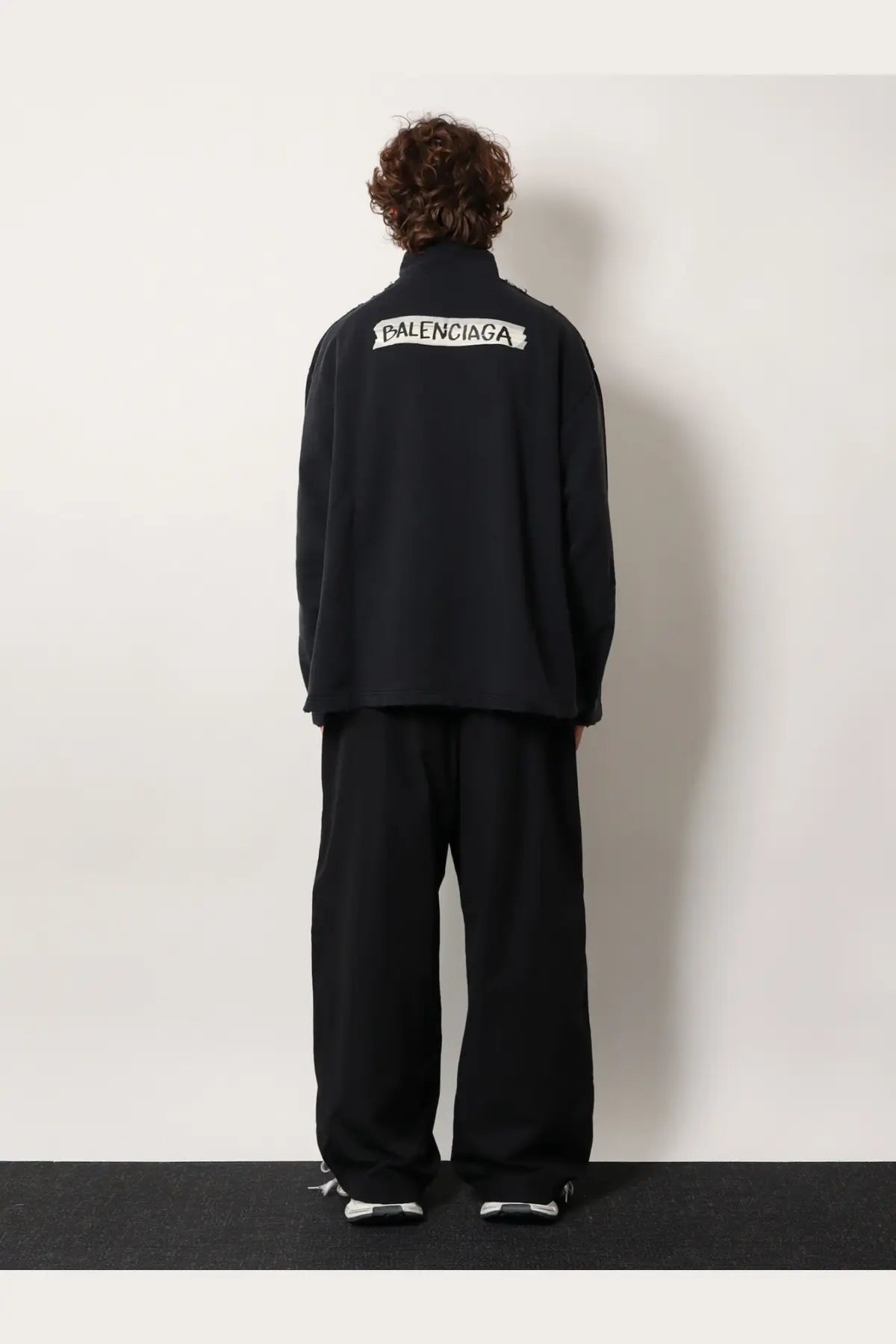 Balenciaga men’s black cotton sweatshirt shown from the back with white embroidered logo on the jacket