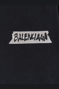 Black balenciaga logo patch with distressed tape design on balenciaga men’s black cotton sweatshirt front