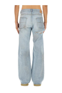 Balenciaga men’s light-wash denim deconstructed jeans with distressed ripped detail on the right thigh blue
