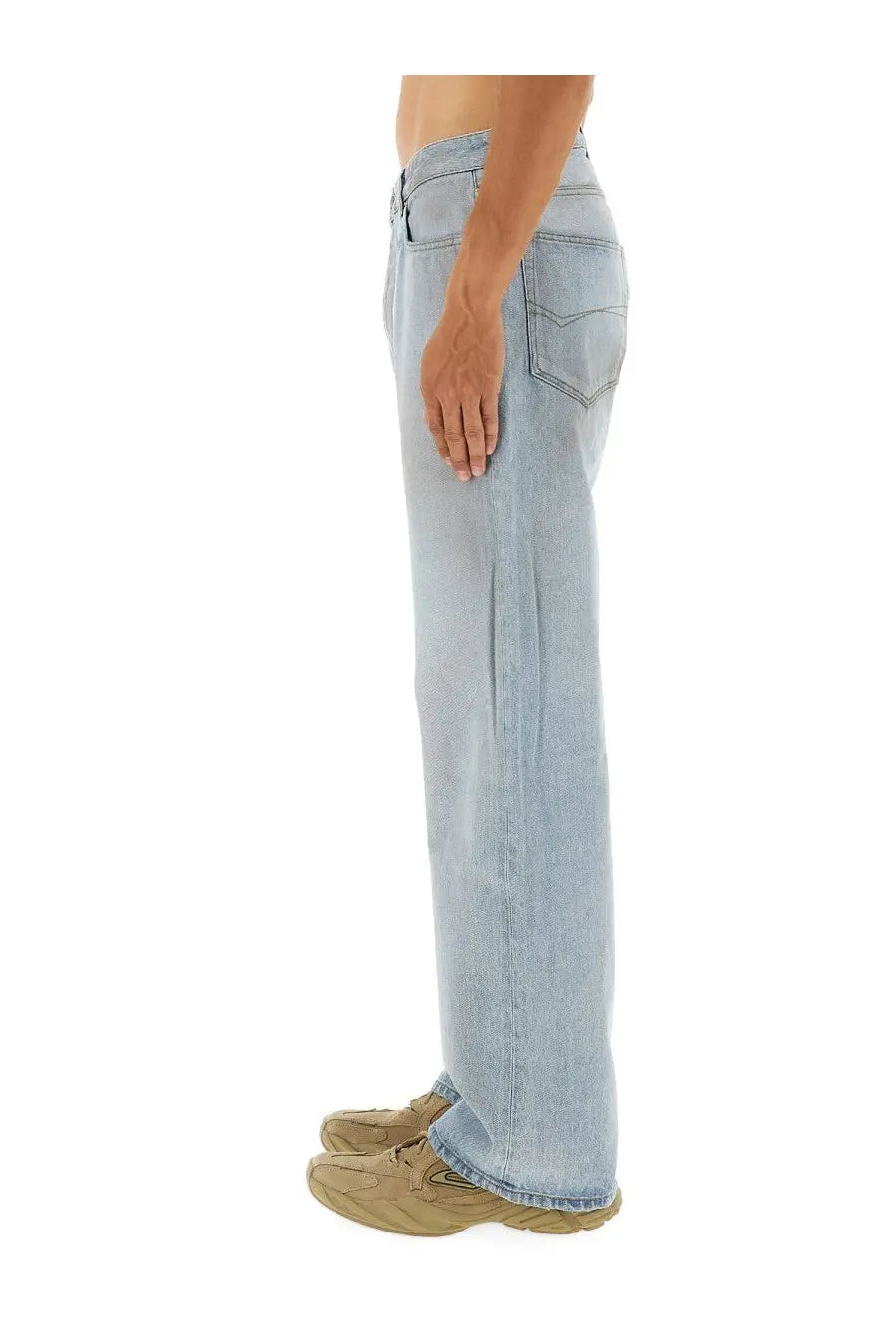Back view of balenciaga men’s deconstructed light-wash denim jeans with relaxed straight-leg cut and classic pockets