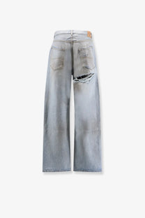 Balenciaga men’s light-wash denim jeans with distressed ripped detail on the right thigh in blue