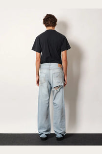 Balenciaga men’s light-wash denim jeans in blue with distressed ripped knee detail for casual wear
