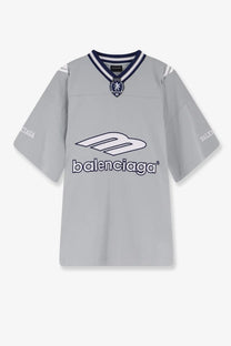 Balenciaga men’s football jersey shirt grey with navy blue and white trim featuring bold m logo and brand name across chest