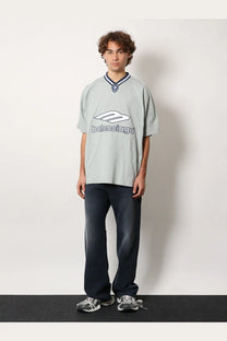 Light gray balenciaga men’s football jersey shirt with white logo and navy blue collar trim in oversized fit