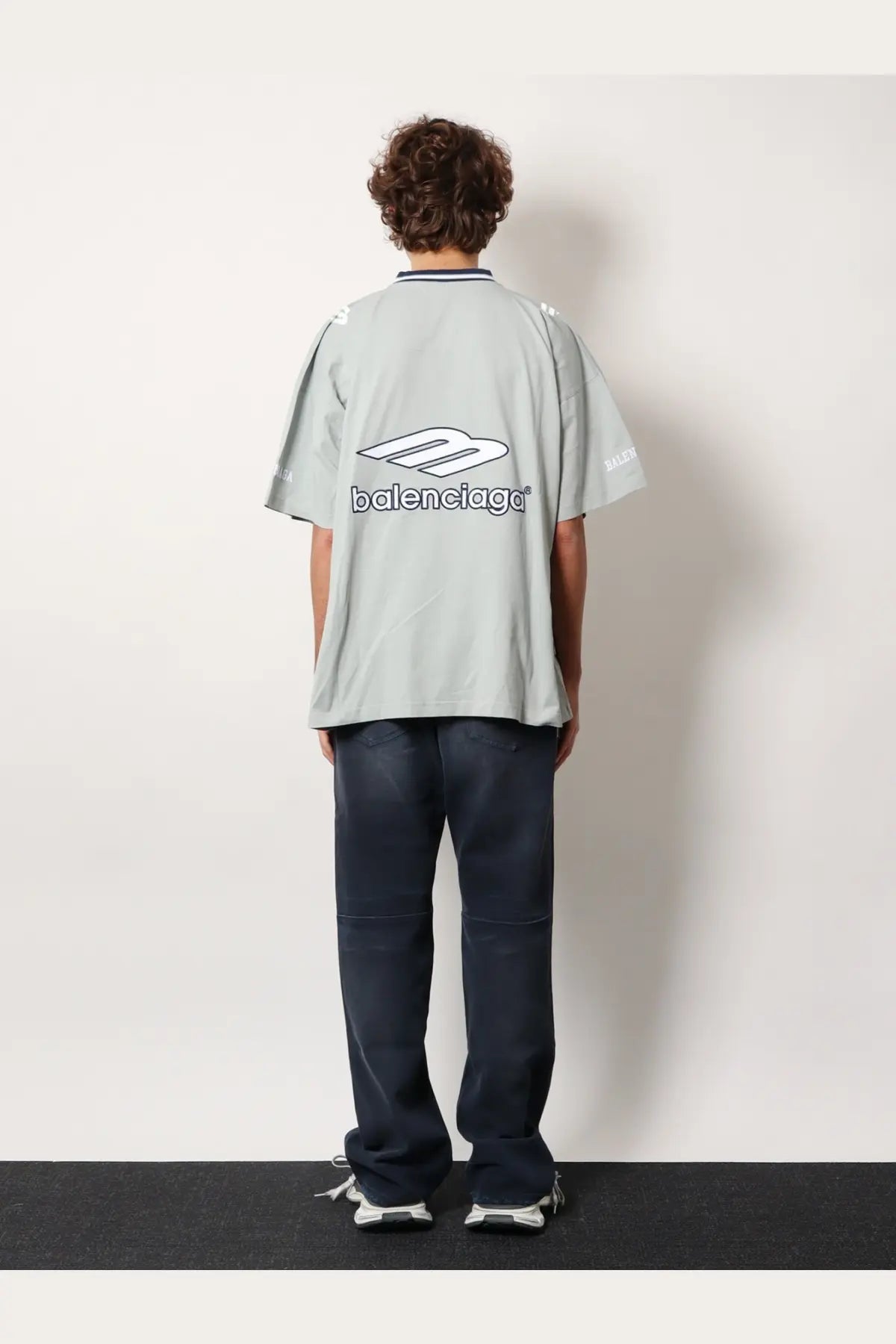 Light gray balenciaga men’s football jersey shirt with bold white logo and black lettering on the back side