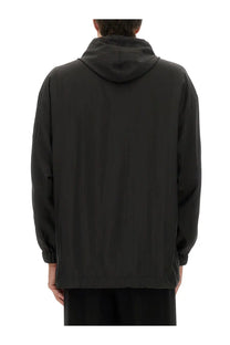 Balenciaga men’s oversized windbreaker black hooded jacket with sleek minimalist design and subtle vertical seams