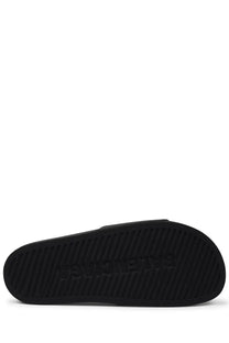 Black rubber sole of balenciaga men’s slip on sandal with embossed branding in black