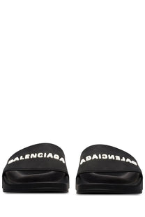 Balenciaga men’s slip on black slide sandals with bold white logo branding across the top for casual wear