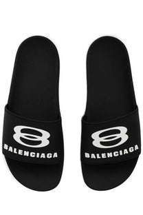 Balenciaga men’s black slide sandals with bold white logo and brand name on the strap