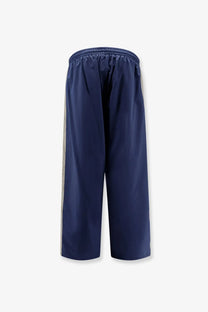 Navy blue Balenciaga men’s sporty nylon trousers with light gray vertical stripes down each side for activewear