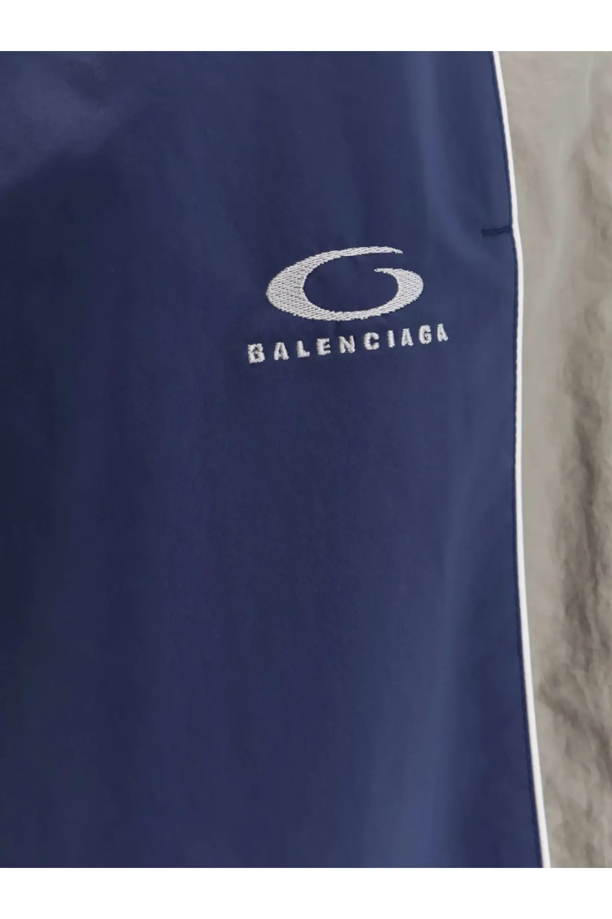 Balenciaga men’s navy blue sporty nylon track pant with white embroidered logo and side stripe
