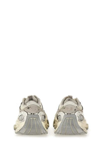 A pair of beige and gray Balenciaga men’s stapler sneakers with chunky layered design and triple s sole