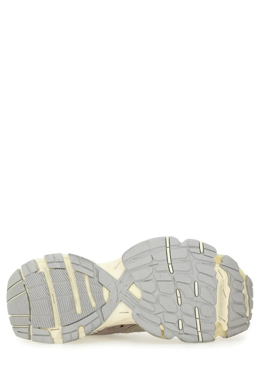 The shoe sole of the balenciaga men’s stapler sneaker beige features a chunky layered gray rubber and cream midsole design