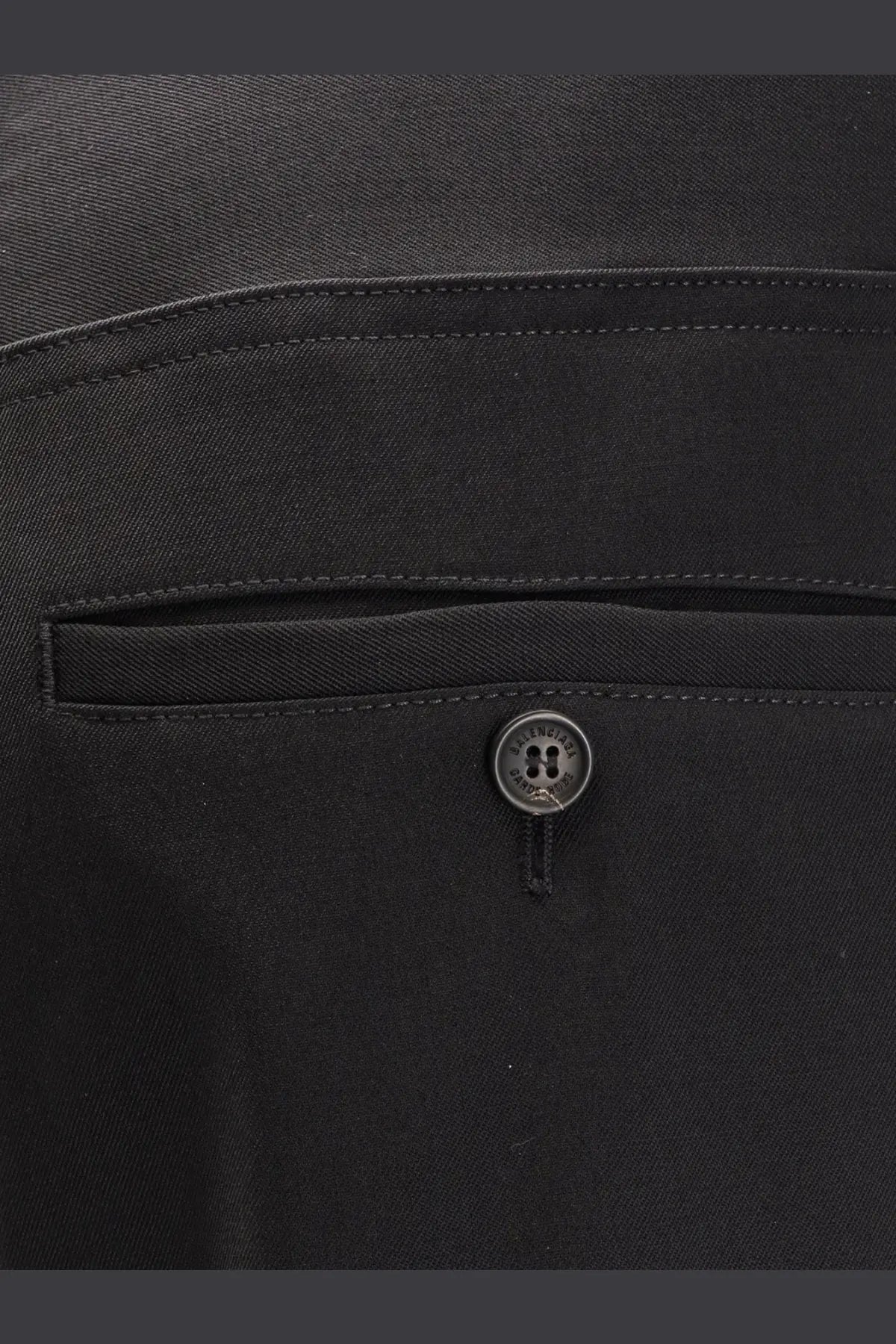 Black balenciaga button with matte finish and four-hole design on mens straight fit cotton trousers