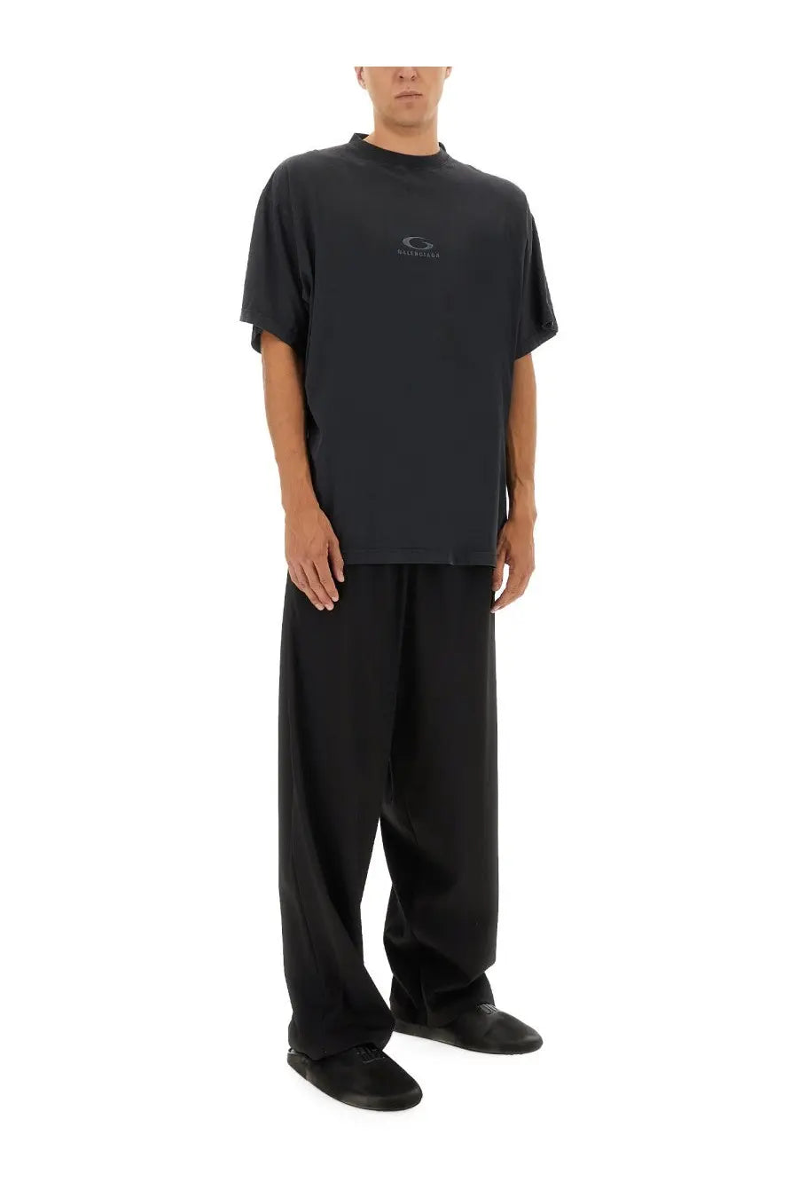 Black oversized Balenciaga t-shirt with subtle chest logo paired with Balenciaga men’s stretch black pants