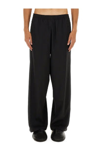 Balenciaga men’s stretch black wide-leg trousers with a relaxed flowing silhouette and elastic waistband