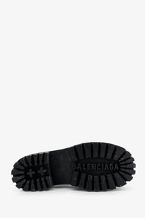 Black rubber sole with deep tread and embossed balenciaga logo on balenciaga men’s strike leather boots black