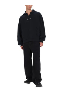 Black Balenciaga men’s sweatshirt hoodie with minimalist white logo on chest made from comfortable material