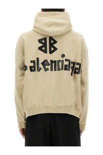 Beige Balenciaga men’s hoodie with bold black logo print featuring tape type design for casual wear