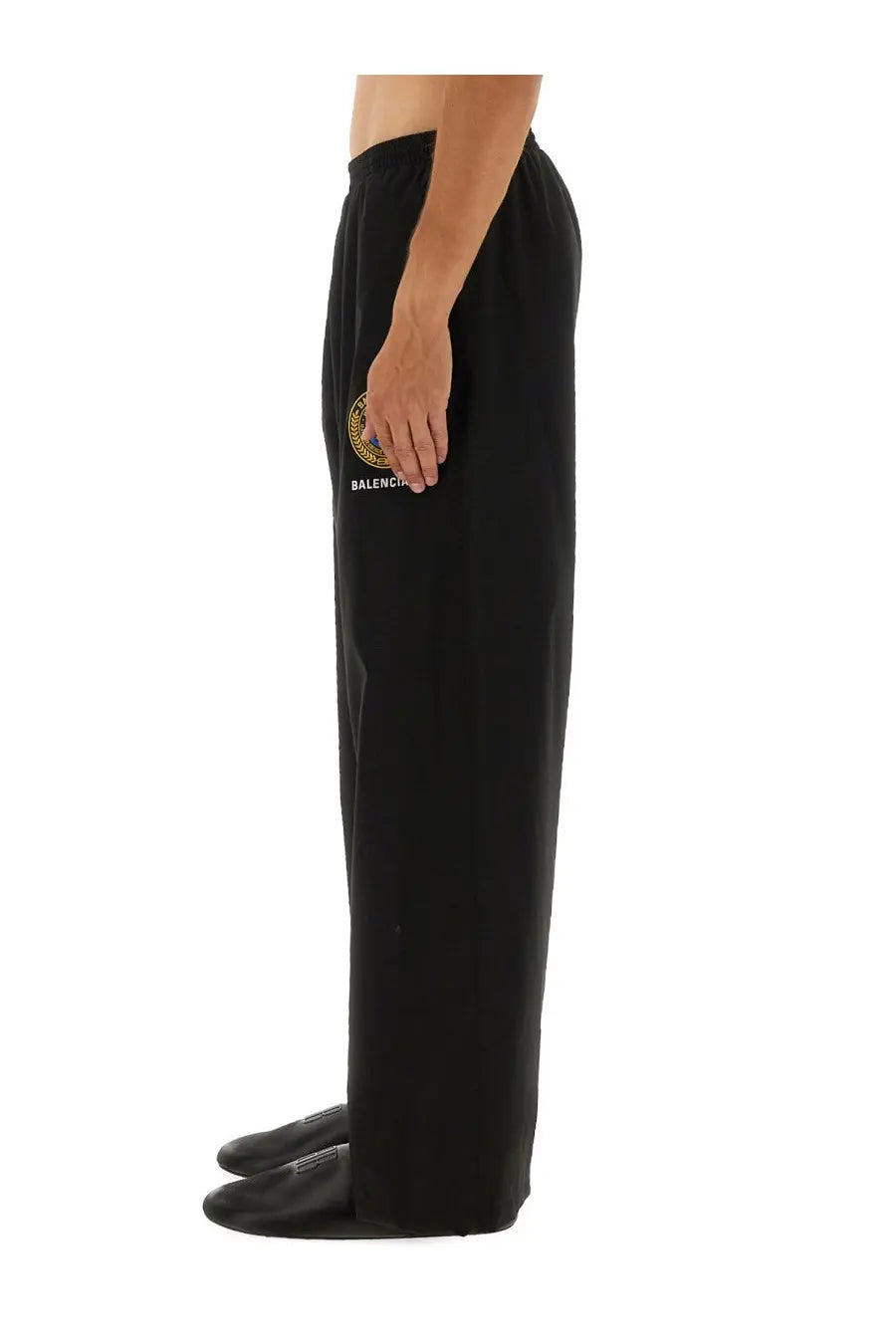 Balenciaga men’s black sweatpants with gold and blue circular logo and embroidered brand name on front