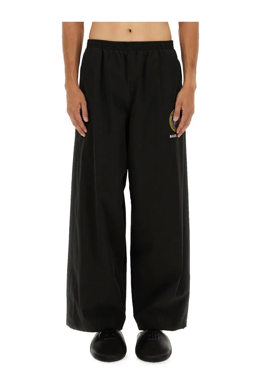 Balenciaga men’s black wide-leg tracksuit pants with drawstring waistband and embroidered logo on left thigh
