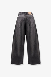 Back view of balenciaga men’s trompe loeil dark gray wide-leg denim trousers with relaxed straight silhouette and classic pockets