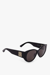 Balenciaga women’s black acetate cat-eye sunglasses with gold-tone bb logo on temples and dark gray lenses