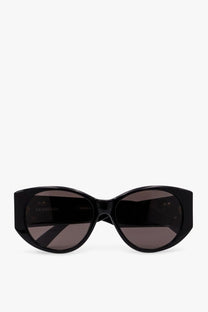 Balenciaga women’s black acetate sunglasses with dark gray lenses and sleek cat-eye frame design