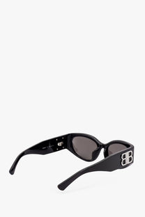 Balenciaga women’s black acetate sunglasses with glossy finish and silver interlocking bb logo on the temple