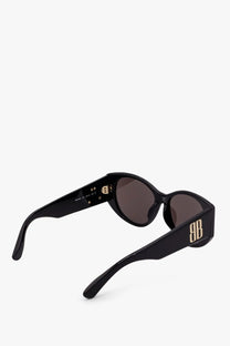 Balenciaga women’s black acetate sunglasses with gold-tone bb logo temples and dark brown lenses