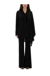 Balenciaga women’s black silk blouse with flowing asymmetrical design and tied bow at the neckline