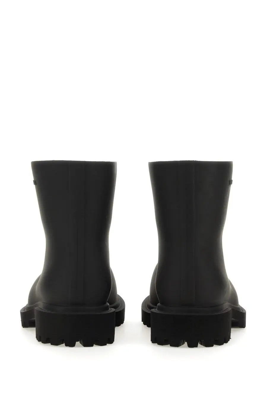 Balenciaga women’s boot Steroid black rubber boots with chunky textured soles shown from the back side