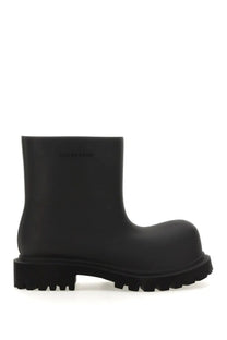 Black rubber balenciaga women’s boot steroid with chunky textured sole and matte finish shown from the back side