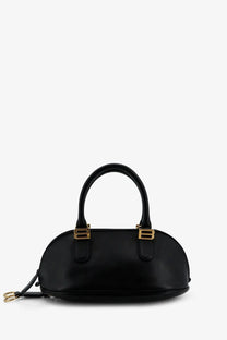 Balenciaga women’s black leather bowling bolero handbag with gold-tone hardware and curved top handle