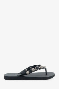 Balenciaga women’s cagole black leather flip-flop with silver-toned studs and buckle detail visible from the back