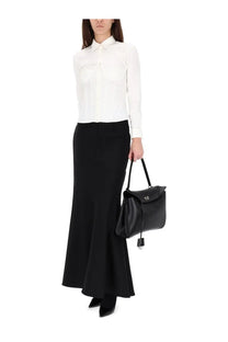 Black leather handbag with flap closure and small metallic logo shown with balenciaga womens corset shirt white